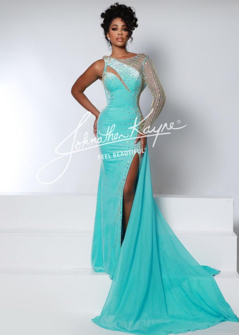 A woman wearing a blue Johnathan Kayne formal dress with long sleeves and a V-neckline.