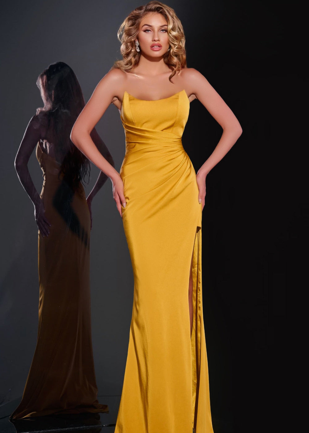 A model wearing a yellow Jovani dress with a straight neckline, sleeveless top, and a side slit.