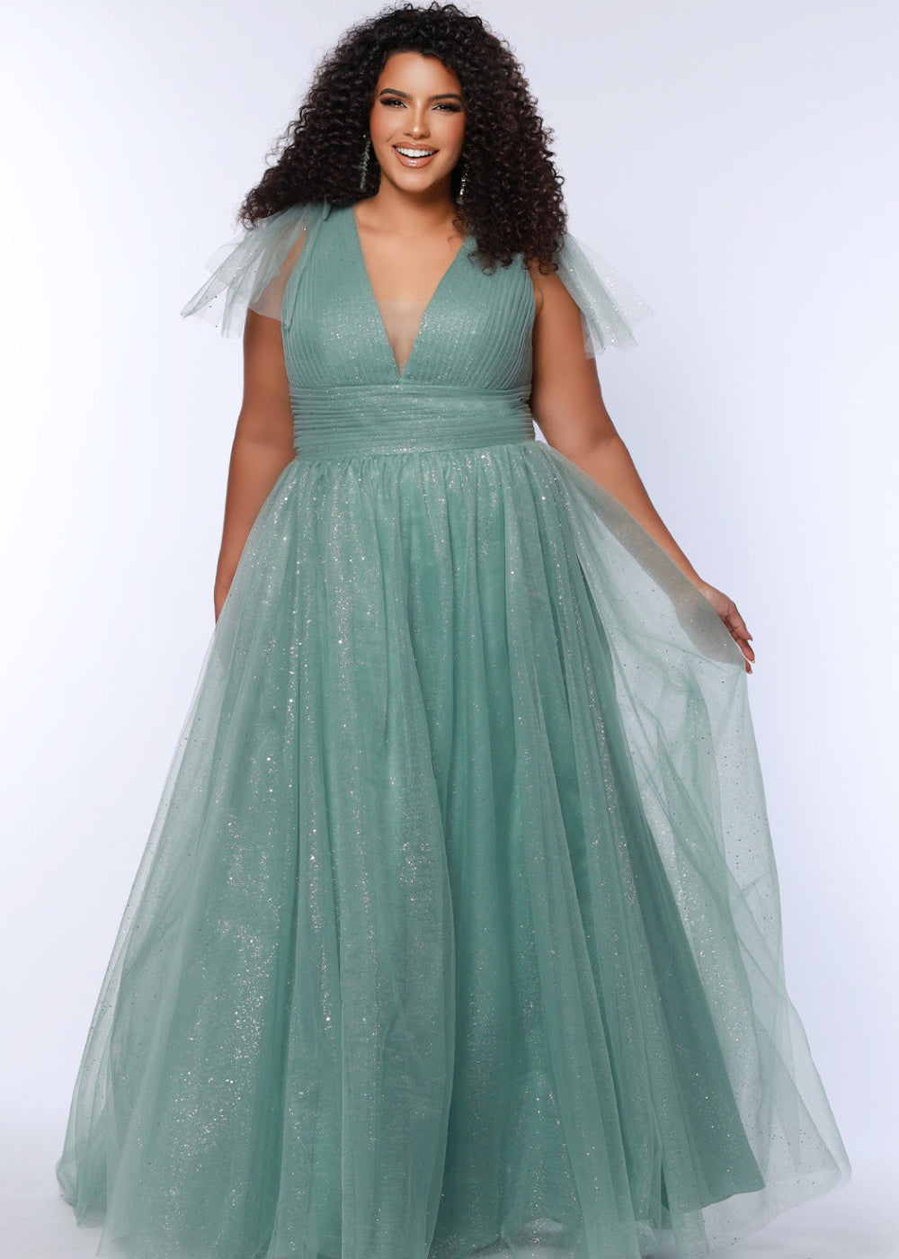 A woman wearing a green, solid pattern, sleeveless, maxi dress with a v-neck neckline.