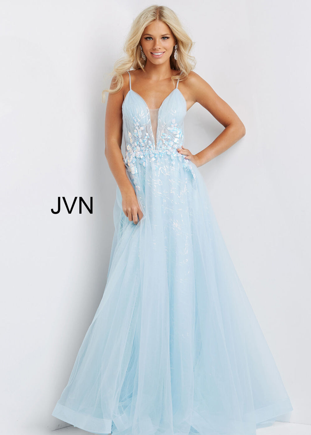 A woman wearing a light blue, sleeveless, maxi dress with lace detailing on the top.